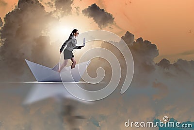 The businesswoman riding paper boat ship in business concept Stock Photo