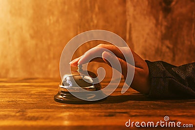 Businesswoman ringing hotel reception bell Stock Photo