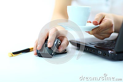 Businesswoman's hand on mouse and cup of coffee Stock Photo