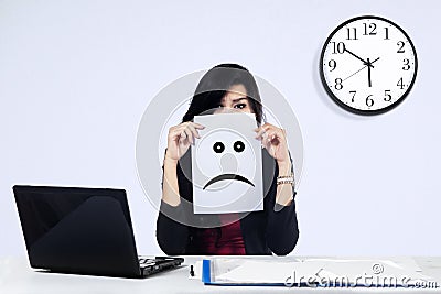 Businesswoman with a sad emoticon Stock Photo