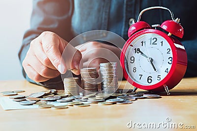 businesswoman saving money with hand putting coins stack and red Stock Photo