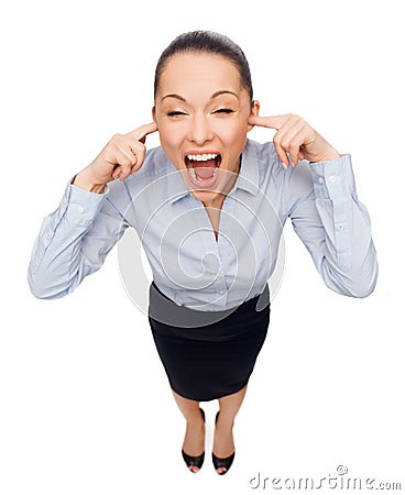 Businesswoman screaming with closed ears Stock Photo