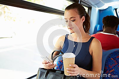 Businesswoman Sending Text Message On Bus Stock Photo