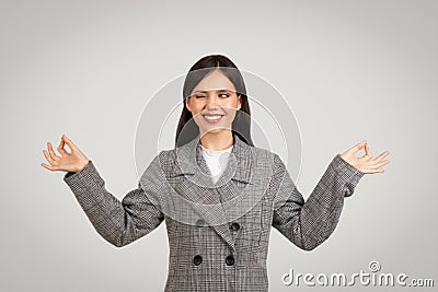 Businesswoman in serene pose, meditating in office attire Stock Photo