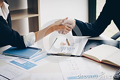 Businesswoman shaking hand for a complete business deal together Stock Photo