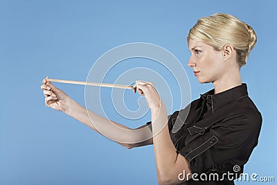 Businesswoman Shooting Rubber Band Stock Photo