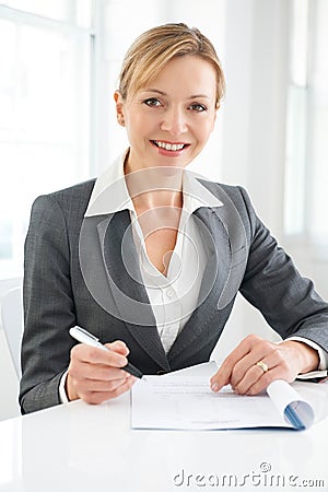 Businesswoman Signing Document Stock Photo