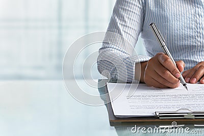 Businesswoman signing paper Stock Photo