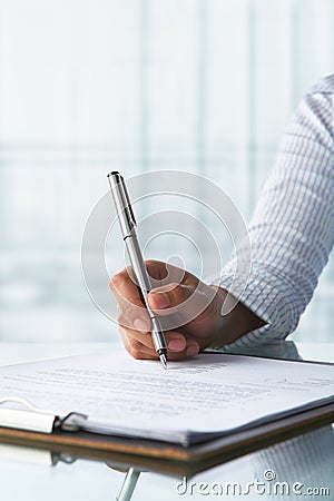 Businesswoman signing paper Stock Photo