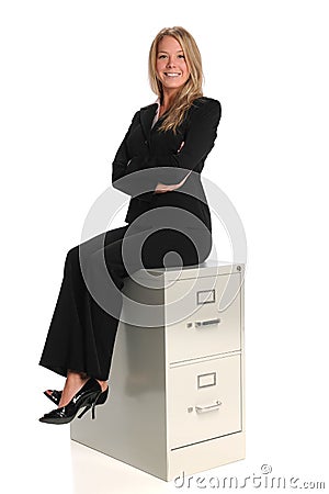 Businesswoman Sitting on File Cabinet Stock Photo