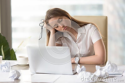 Businesswoman sleeping with head on hand at work Stock Photo