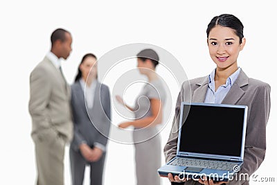 Businesswoman smiling showing a laptop screen Stock Photo