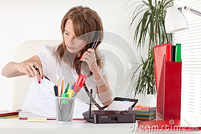 Businesswoman speaks by phone at the office. Stock Photo