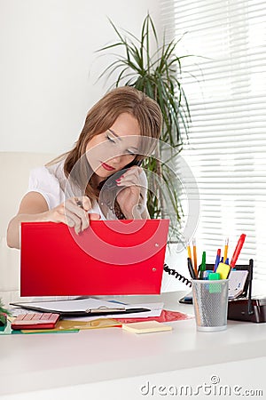 Businesswoman speaks by phone at the office. Stock Photo