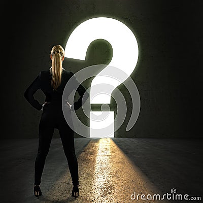 Businesswoman standing in front of a portal shaped as a questionmark Stock Photo