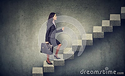 Businesswoman stepping up a stairway career ladder Stock Photo