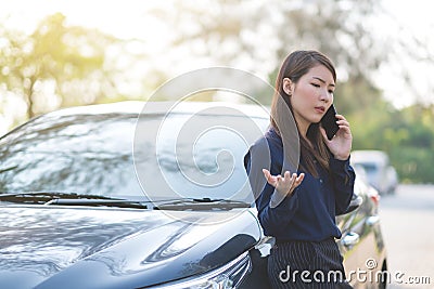Businesswoman stop a car and talking on phone for her busi Stock Photo