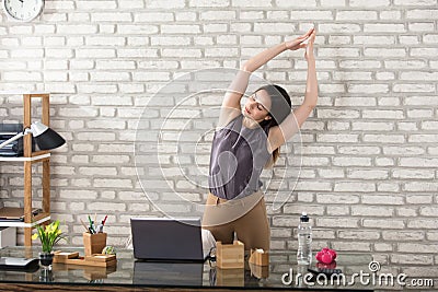 Businesswoman Stretching Stock Photo