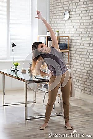 Businesswoman Stretching Stock Photo