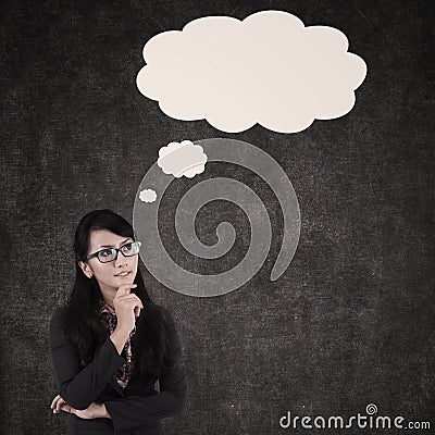 Businesswoman thinking and cloud copyspace Stock Photo