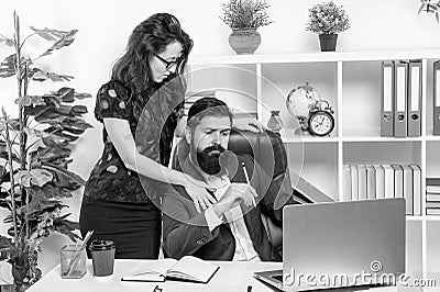 Businesswoman touching businessman working in office, workplace flirtation Stock Photo