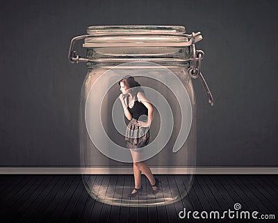 Businesswoman trapped into a glass jar concept Stock Photo