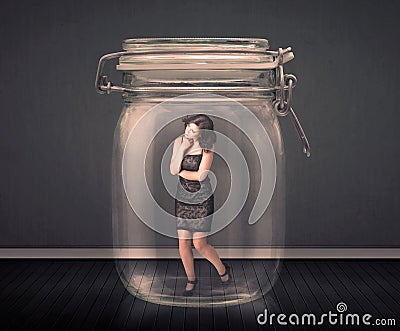 Businesswoman trapped into a glass jar concept Stock Photo