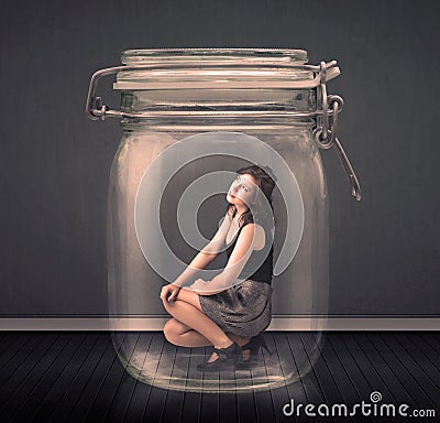 Businesswoman trapped into a glass jar concept Stock Photo