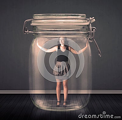 Businesswoman trapped into a glass jar concept Stock Photo
