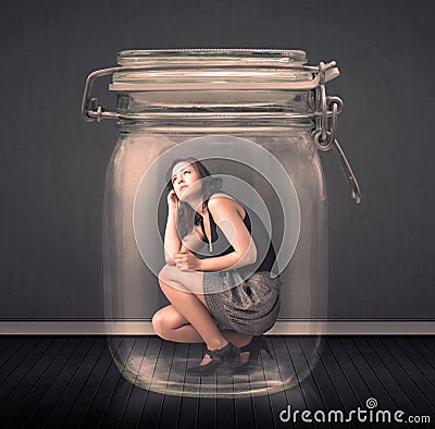 Businesswoman trapped into a glass jar concept Stock Photo