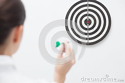 Businesswoman trying hit bullseye Stock Photo