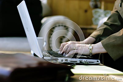 Businesswoman Typing in Hotel Atrium Stock Photo