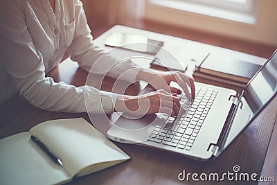 Businesswoman typing on laptop at workplace Woman working in home office hand keyboard. Stock Photo