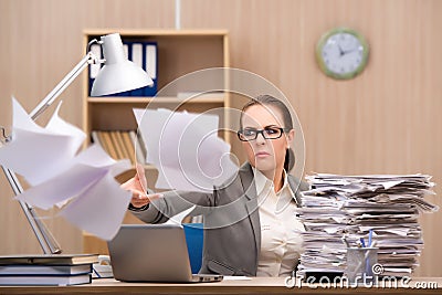 The businesswoman under stress from too much work in the office Stock Photo