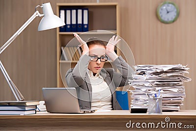 The businesswoman under stress from too much work in the office Stock Photo