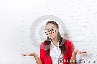 Businesswoman unsure gesture wear red jacket glasses confused shrug shoulders Stock Photo