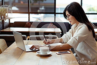 Businesswoman use laptop and pointing plan income balance Stock Photo