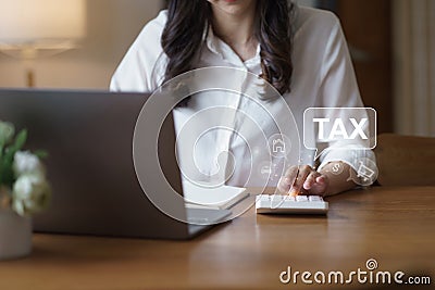 Businesswoman using laptop for online income tax return form. Symbolic of financial research, government taxes, and tax Stock Photo