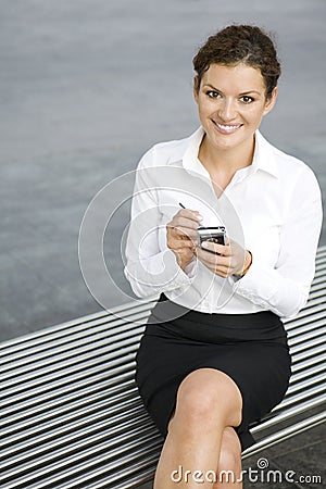 Businesswoman using palmtop Stock Photo