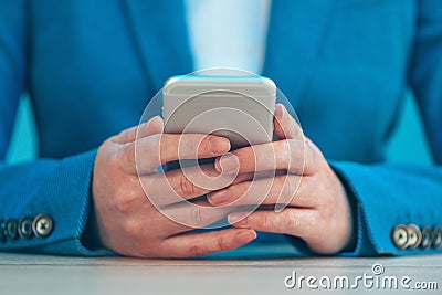 Businesswoman using smartphone, close up of hands Stock Photo