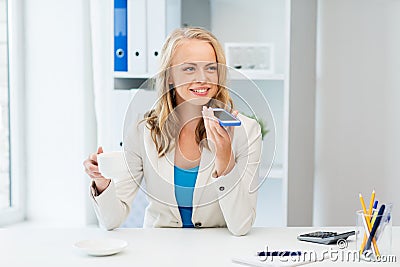Businesswoman using voice command on smartphone Stock Photo