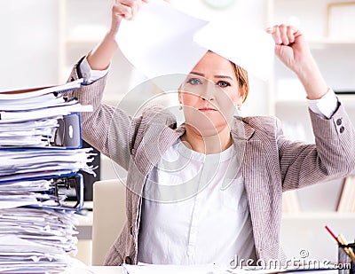 Businesswoman very busy with ongoing paperwork Stock Photo