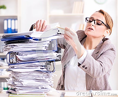 Businesswoman very busy with ongoing paperwork Stock Photo