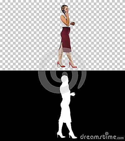 Businesswoman walking and making a call, Alpha Channel Stock Photo