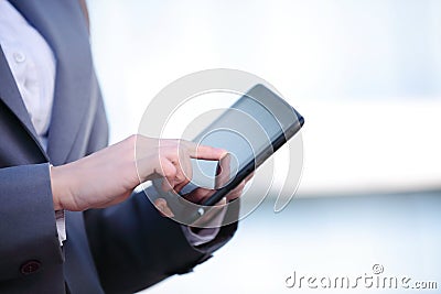 Businesswoman working on digital tablet outdoor over building background Stock Photo
