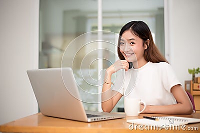 Businesswoman working at home with laptop for surfing the internet for commercial. Online shopping business and Relax on holiday Stock Photo