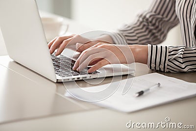 Businesswoman working on laptop, female hands typing on keyboard Stock Photo