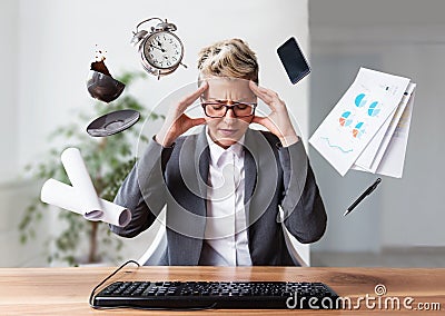 Businesswoman working on a laptop, overworking, under pressure Stock Photo