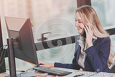 Businesswoman working in office with business phone call while using computer at office desk Stock Photo