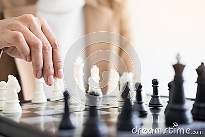 Businesswomen playing chess game makes her move Stock Photo